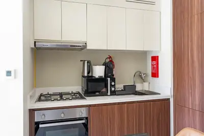 a kitchen with a stove and a microwave at Aliving Exclusive 1BR Reva Residence Business Bay-218 in Dubai