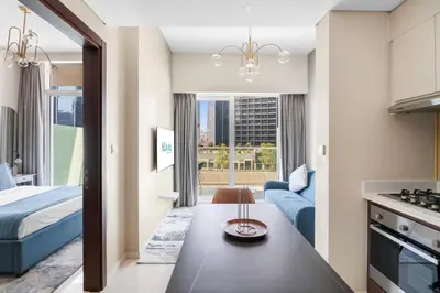 a living room with a bed and a table in a room at Aliving Exclusive 1BR Reva Residence Business Bay-218 in Dubai