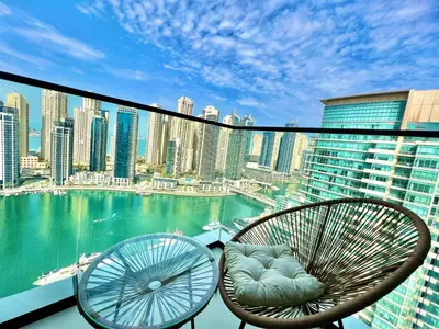 a balcony with chairs and a view of the city at VIDA Residences Dubai Marina 1BR - Seaview, JBR, Dubai Eye in Dubai