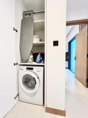 a washer and dryer in a white laundry room at VIDA Residences Dubai Marina 1BR - Seaview, JBR, Dubai Eye in Dubai
