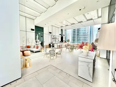 a lobby of a building with tables and chairs at VIDA Residences Dubai Marina 1BR - Seaview, JBR, Dubai Eye in Dubai