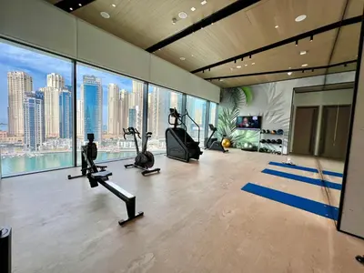 a gym with treadmills and exercise bikes in a building at VIDA Residences Dubai Marina 1BR - Seaview, JBR, Dubai Eye in Dubai