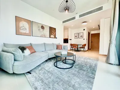 a living room with a couch and a table at VIDA Residences Dubai Marina 1BR - Seaview, JBR, Dubai Eye in Dubai