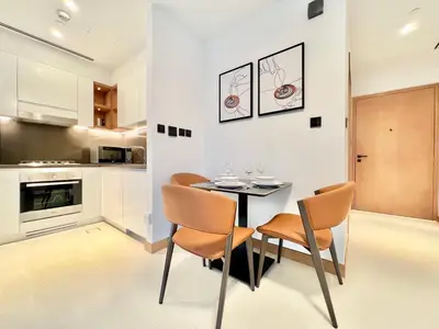 a kitchen and dining room with a table and chairs at VIDA Residences Dubai Marina 1BR - Seaview, JBR, Dubai Eye in Dubai
