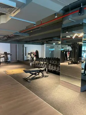 a gym with a bench and chairs and a mirror at Urban Elegance new studio near Dubai Mall & Burj in Dubai