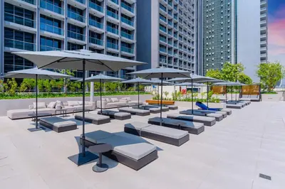 a row of tables and umbrellas in a courtyard at Urban Elegance new studio near Dubai Mall & Burj in Dubai