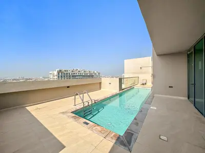 a swimming pool on the roof of a building at StoneTree - Cozy 1 BR Apartment in Al Furjan in Dubai