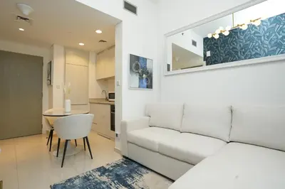 a living room with a white couch and a table at Cozy Flat in Business Bay in Dubai