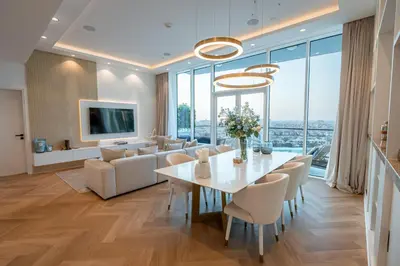 a living room with a white table and chairs at Daniels Sea View 2BR in Oceana The Palm Jumeirah in Dubai