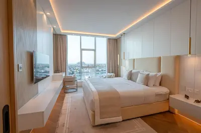 a hotel room with a bed and a large window at Daniels Sea View 2BR in Oceana The Palm Jumeirah in Dubai