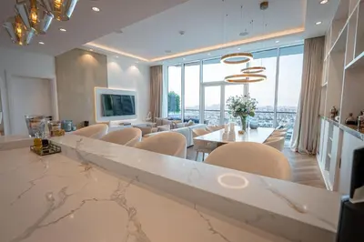 a dining room with a marble table and chairs at Daniels Sea View 2BR in Oceana The Palm Jumeirah in Dubai