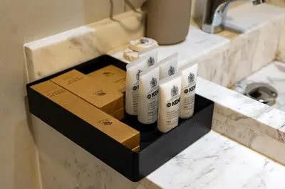 a box of toiletries on a counter in a bathroom at Lux BnB Travo Tower I Private Garden I Lake View in Dubai