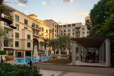 a view of a courtyard with a pool and buildings at Lux BnB Travo Tower I Private Garden I Lake View in Dubai