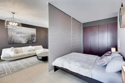 a bedroom with a bed and a couch at Studio sea view in Dubai
