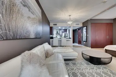 a living room with a white couch and a table at Studio sea view in Dubai