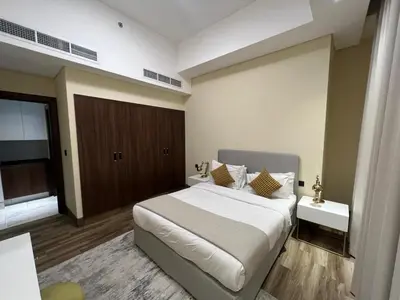 a bedroom with a large white bed and a window at Elegant 1bedroom in J ONE in Dubai