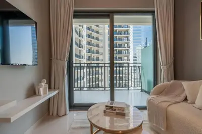 a living room with a couch and a large window at The View 1 Bedroom in Dubai