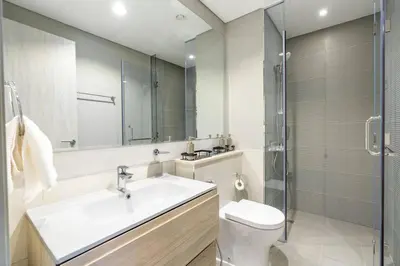 a bathroom with a sink and a toilet and a shower at The View 1 Bedroom in Dubai