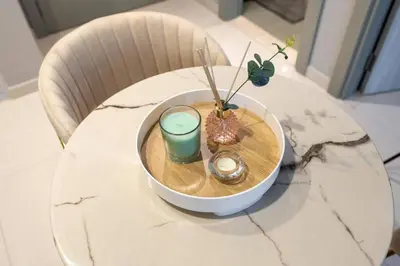 a table with a bowl with a drink and plants on it at The View 1 Bedroom in Dubai