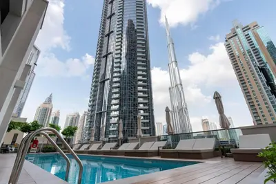 a pool with a view of a tall building at White Sage - Act One Tower in Dubai