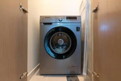 a washing machine in a room with two doors at White Sage - Act One Tower in Dubai
