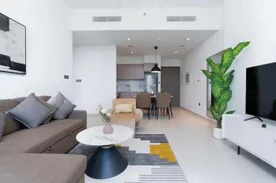 a living room with a couch and a table at White Sage - Act One Tower in Dubai