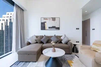a living room with a couch and a table at White Sage - Act One Tower in Dubai