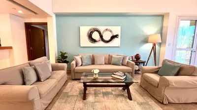 a living room with two couches and a coffee table at Direct Access to Nakheel Mall At the Heart of The Palm in Dubai