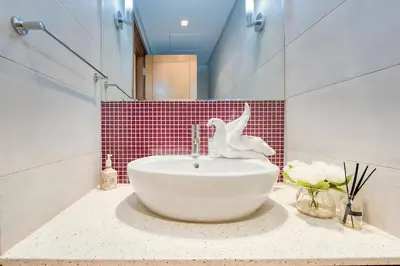 a bathroom with a sink with a bird statue on it at Direct Access to Nakheel Mall At the Heart of The Palm in Dubai
