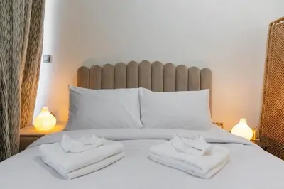 a white bed with two folded towels on it at Nice Studio in Azizi Riviera 32 - Dubai in Dubai