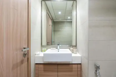 a bathroom with a white sink and a mirror at Nice Studio in Azizi Riviera 32 - Dubai in Dubai