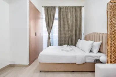 a bedroom with a white bed with a window at Nice Studio in Azizi Riviera 32 - Dubai in Dubai