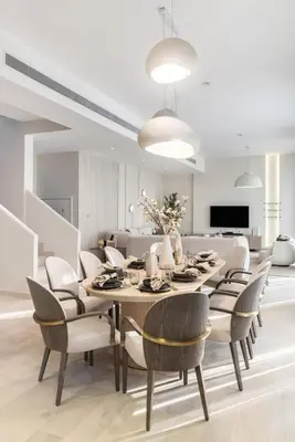 a dining room with a table and chairs at Stunning Palm Villa with Rooftop Garden, Resort Style Pool and Beach by Exclusive Holiday Homes in Dubai