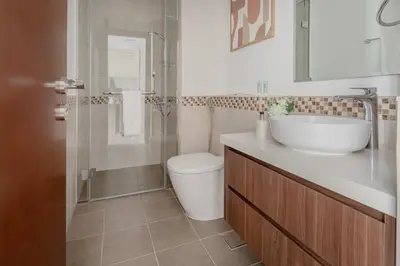 a bathroom with a toilet and a sink and a shower at Frank Porter - Vera Residence in Dubai