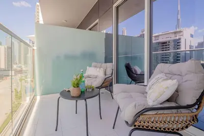 a balcony with a couch and a table on a building at Frank Porter - Vera Residence in Dubai