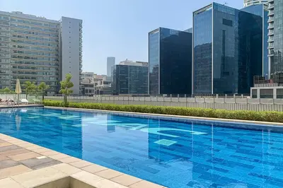 a large blue swimming pool on top of a building at Frank Porter - Vera Residence in Dubai