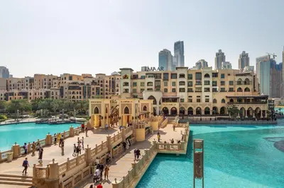 a bridge over a river with a city in the background at Frank Porter - Vera Residence in Dubai