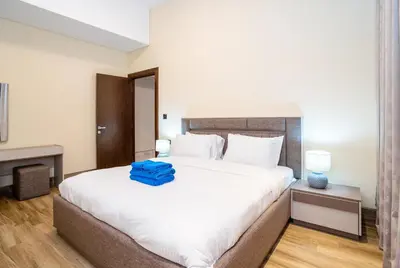a bedroom with a large bed with a blue bag on it at New Arabian 2 Bedroom J One Tower Business Bay in Dubai