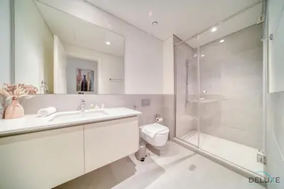 a bathroom with a toilet sink and a shower at Capacious 2BR at Sunset at Creek Beach 3 Dubai Creek Harbor by Deluxe Holiday Homes in Dubai
