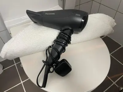 a hair dryer sitting on top of a toilet at Studio close to Burj Khalifa and Downtown Dubai in Dubai