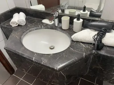 a bathroom counter with a sink and a hair dryer at Studio close to Burj Khalifa and Downtown Dubai in Dubai
