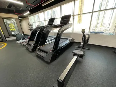 a gym with several treadmills in a room at Studio close to Burj Khalifa and Downtown Dubai in Dubai
