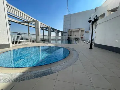 a swimming pool on the roof of a building at Studio close to Burj Khalifa and Downtown Dubai in Dubai