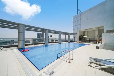 a large swimming pool on top of a building at Studio close to Burj Khalifa and Downtown Dubai in Dubai