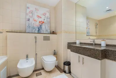 a bathroom with a toilet and a sink at Perfect 2BD apartment in the heart of Marina - top spot in Dubai