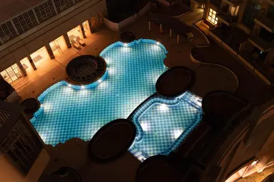 an overhead view of a large swimming pool at night at Burj Khalifa Views / 5 min walk from Dubai Mall / Dubai Opera / Upgraded / Designer Choice / 8 people / The Best Location in Dubai