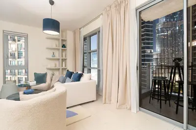 a living room with a white couch and large windows at Burj Khalifa Views / 5 min walk from Dubai Mall / Dubai Opera / Upgraded / Designer Choice / 8 people / The Best Location in Dubai