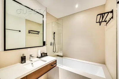 a bathroom with a sink and a tub and a mirror at Vida Residences Dubai Marina by Emaar in Dubai