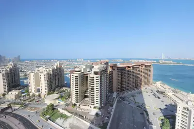 an aerial view of a city with buildings and the ocean at Livbnb Suites - 1BR w/ Sea View in Palm Tower in Dubai