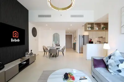 a living room with a couch and a table at Livbnb Suites - Lavish 2BR w/ Burj Khalifa Views & Near Dubai Mall in Dubai